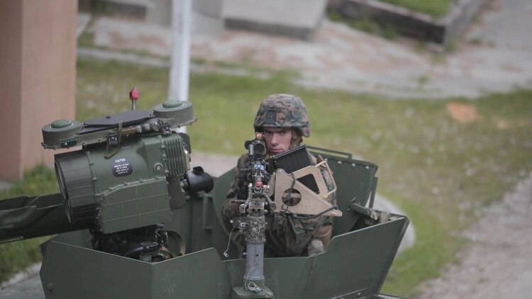 A Marine with Charlie Company, 1st Battalion, 8th Regiment, operates an M240B medium machine gun turret atop a Humvee during a field exercise aboard Camp Lejeune, N.C., Aug. 25, 2015. Marines with 1/8 assaulted a simulated town, set up a defensive position and waited to repel simulated attacks in preparation for their upcoming deployment with Special Purpose Marine Air Ground Task Force Crisis Response. 