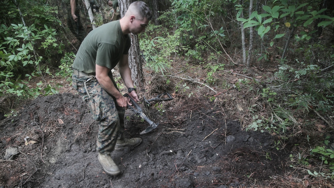 A Marine with Charlie Company, 1st Battalion, 8th Marine Regiment, 2nd Marine Division, digs a skirmisher trench for a defensive position during a field exercise aboard Camp Lejeune, N.C., Aug. 25, 2015. The unit hiked to Training Landing Zone Swan, set up defensive and offensive positions, then waited to encounter simulated attacks in preparation for their upcoming deployment with Special Purpose Marine Air Ground Task Force Crisis Response. 