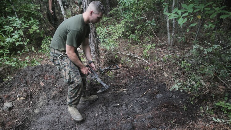 A Marine with Charlie Company, 1st Battalion, 8th Marine Regiment, 2nd Marine Division, digs a skirmisher trench for a defensive position during a field exercise aboard Camp Lejeune, N.C., Aug. 25, 2015. The unit hiked to Training Landing Zone Swan, set up defensive and offensive positions, then waited to encounter simulated attacks in preparation for their upcoming deployment with Special Purpose Marine Air Ground Task Force Crisis Response. 