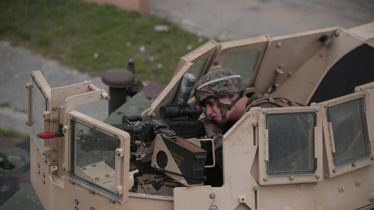 A Marine with Charlie Company, 1st Battalion, 8th Regiment, operates an M240B medium machine gun turret on a Humvee during a field exercise aboard Camp Lejeune, N.C., Aug. 25, 2015. Marines with 1/8 assaulted a simulated town, set up a defensive position and waited to repel simulated attacks in preparation for their upcoming deployment with Special Purpose Marine Air Ground Task Force Crisis Response. 