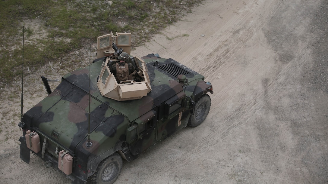 A Marine with Charlie Company, 1st Battalion, 8th Marine Regiment, operates an M240B medium machine gun turret during a field exercise aboard Camp Lejeune, N.C., Aug. 25, 2015. Marines with the unit assaulted a simulated town, set up a defensive position and repelled simulated enemy attacks in preparation for their upcoming deployment with Special Purpose Marine Air Ground Task Force Crisis Response.