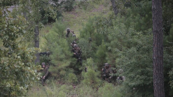 Marines with Charlie Company, 1st Battalion, 8th Regiment, advance on a simulated village during a field exercise aboard Camp Lejeune, N.C., Aug. 25, 2015. They assaulted a simulated town, set up a defensive position and waited to repel simulated attacks in preparation for their upcoming deployment with Special Purpose Marine Air Ground Task Force Crisis Response. 