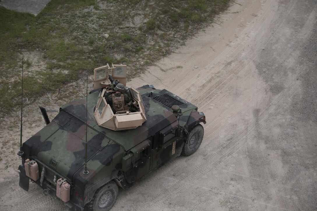 A Marine with Charlie Company, 1st Battalion, 8th Marine Regiment, operates an M240B medium machine gun turret during a field exercise aboard Camp Lejeune, N.C., Aug. 25, 2015. Marines with the unit assaulted a simulated town, set up a defensive position and repelled simulated enemy attacks in preparation for their upcoming deployment with Special Purpose Marine Air Ground Task Force Crisis Response. (U.S. Marine Corps photo by Lance Cpl. Aaron Fiala/Released.)