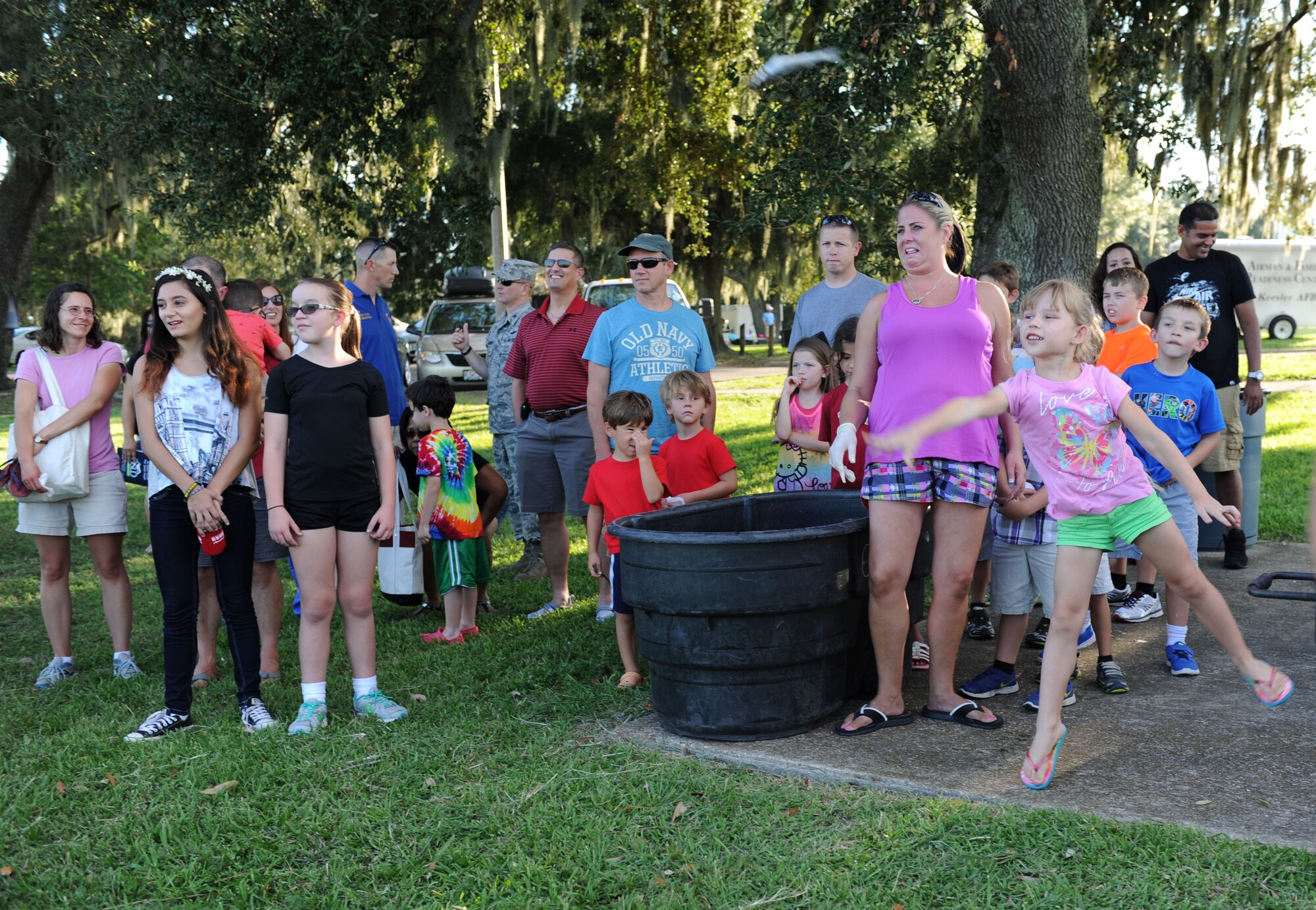 Margarita Ramsey, daughter of Master Sgt. Elijah Ramsay, III, 403rd Wing ground safety manager, participates in the mullet toss during the end-of-summer family picnic at Marina Park Aug. 27, 2015, at Keesler Air Force Base, Miss. The 81st Force Support Squadron-sponsored event also featured a watermelon eating contest and complimentary snowballs. (U.S. Air Force photo by Kemberly Groue)