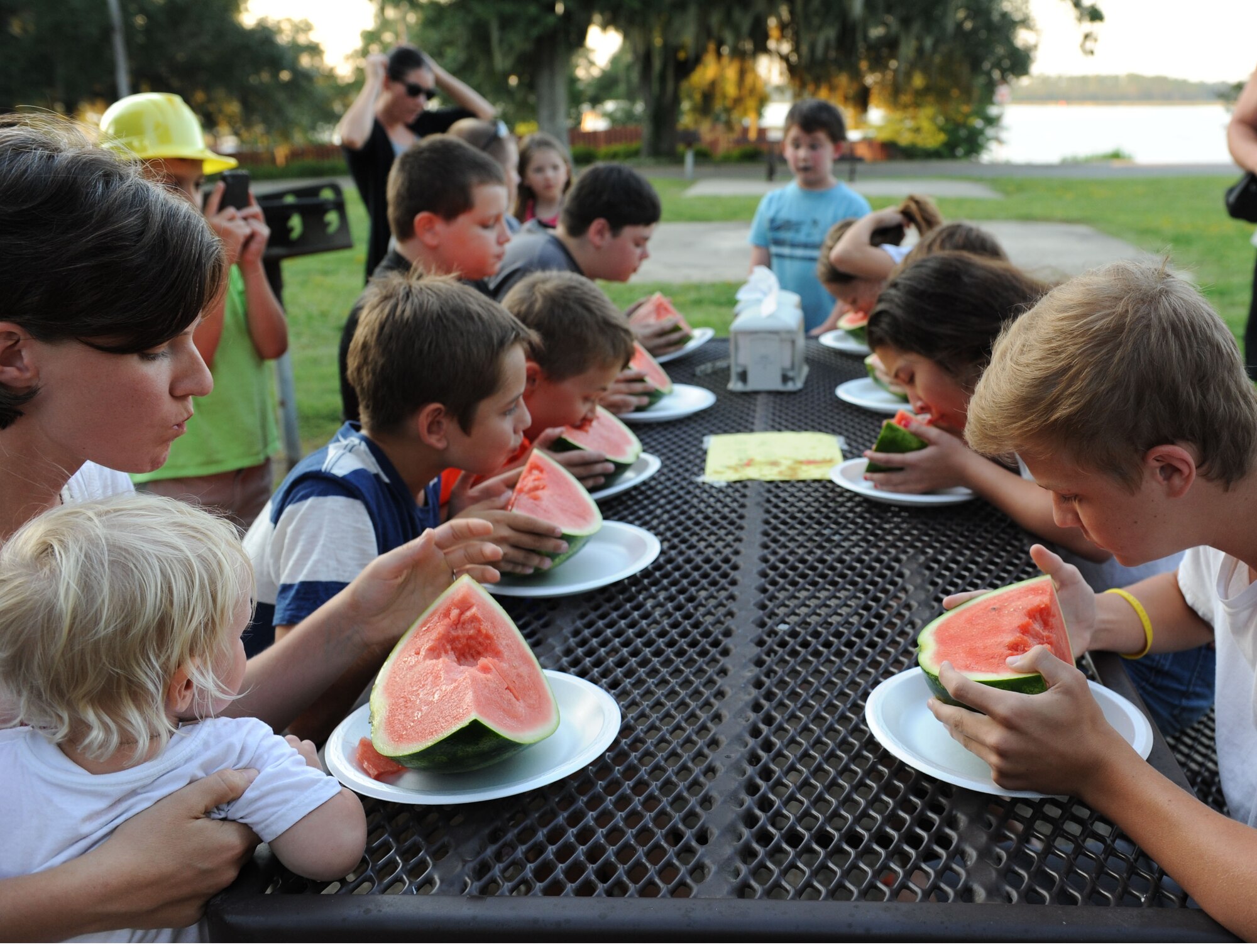 Keesler families participate in the watermelon eating contest during the end-of-summer family picnic at Marina Park Aug. 27, 2015, at Keesler Air Force Base, Miss. The 81st Force Support Squadron-sponsored event also featured a mullet toss and barbeque. (U.S. Air Force photo by Kemberly Groue)