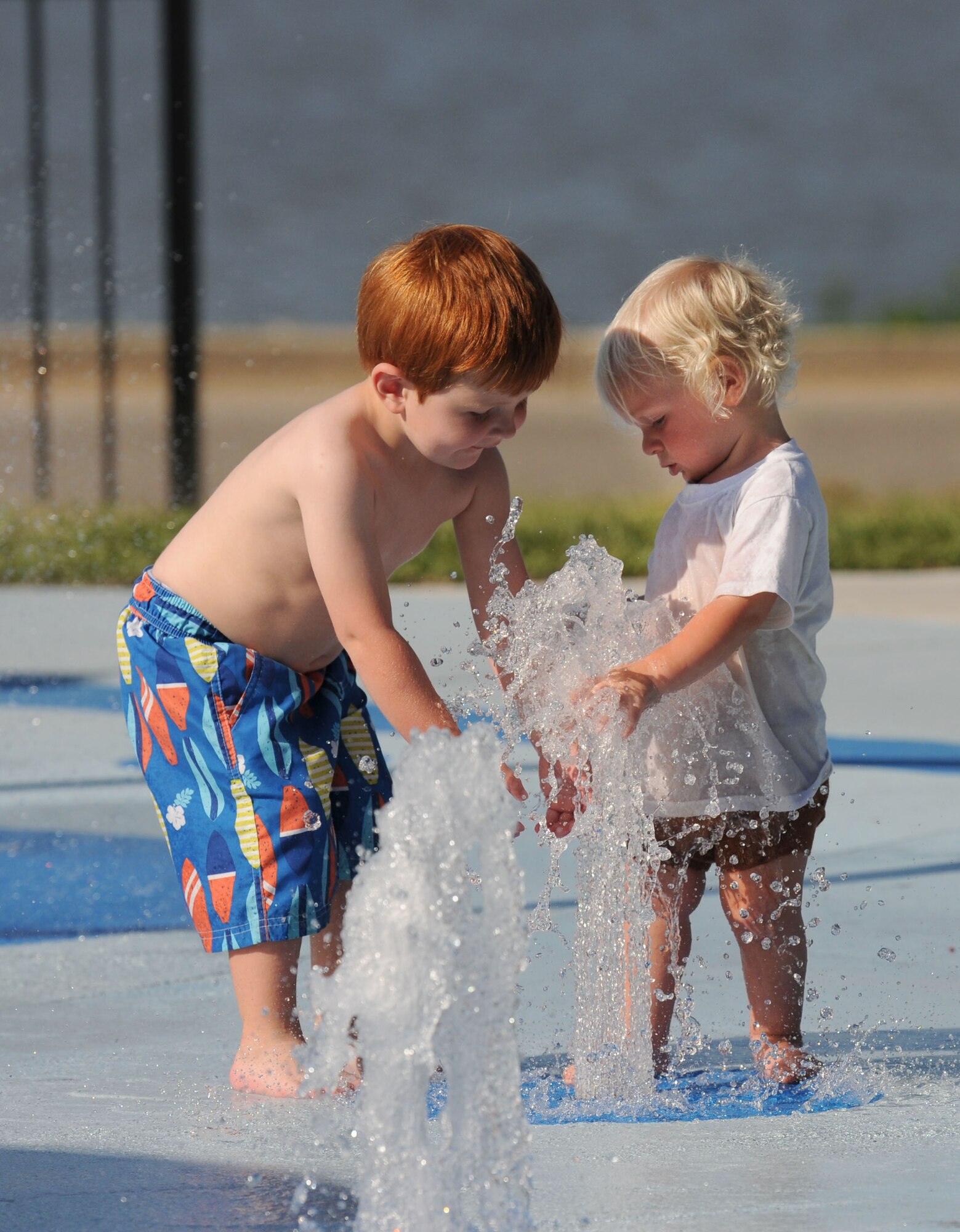 Gunner Ramey, son of Heather Ramey, 81st Force Support Squadron Bay Breeze Event Center catering manager, and Seth Block, son of Airman 1st Class Matthew Block, 338th Training Squadron student, play on the splash pad during the end-of-summer family picnic at Marina Park Aug. 27, 2015, at Keesler Air Force Base, Miss. The 81st Force Support Squadron-sponsored event featured a mullet toss, watermelon eating contest and barbeque. (U.S. Air Force photo by Kemberly Groue)