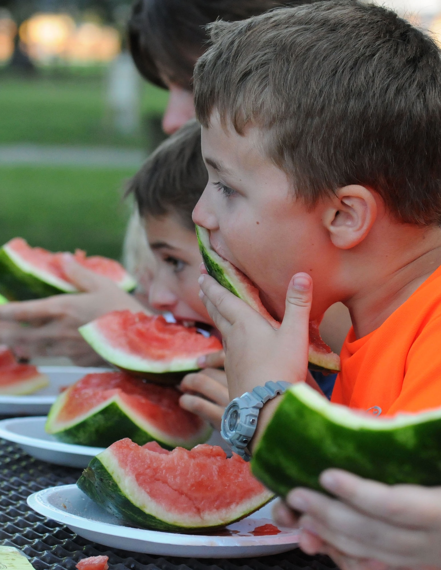 David Solomon, son of Col. Scott Solomon, 81st Training Group commander, participates in the watermelon eating contest during the end-of-summer family picnic at Marina Park Aug. 27, 2015, at Keesler Air Force Base, Miss. The 81st Force Support Squadron-sponsored event also consisted of a mullet toss and barbeque. (U.S. Air Force photo by Kemberly Groue)