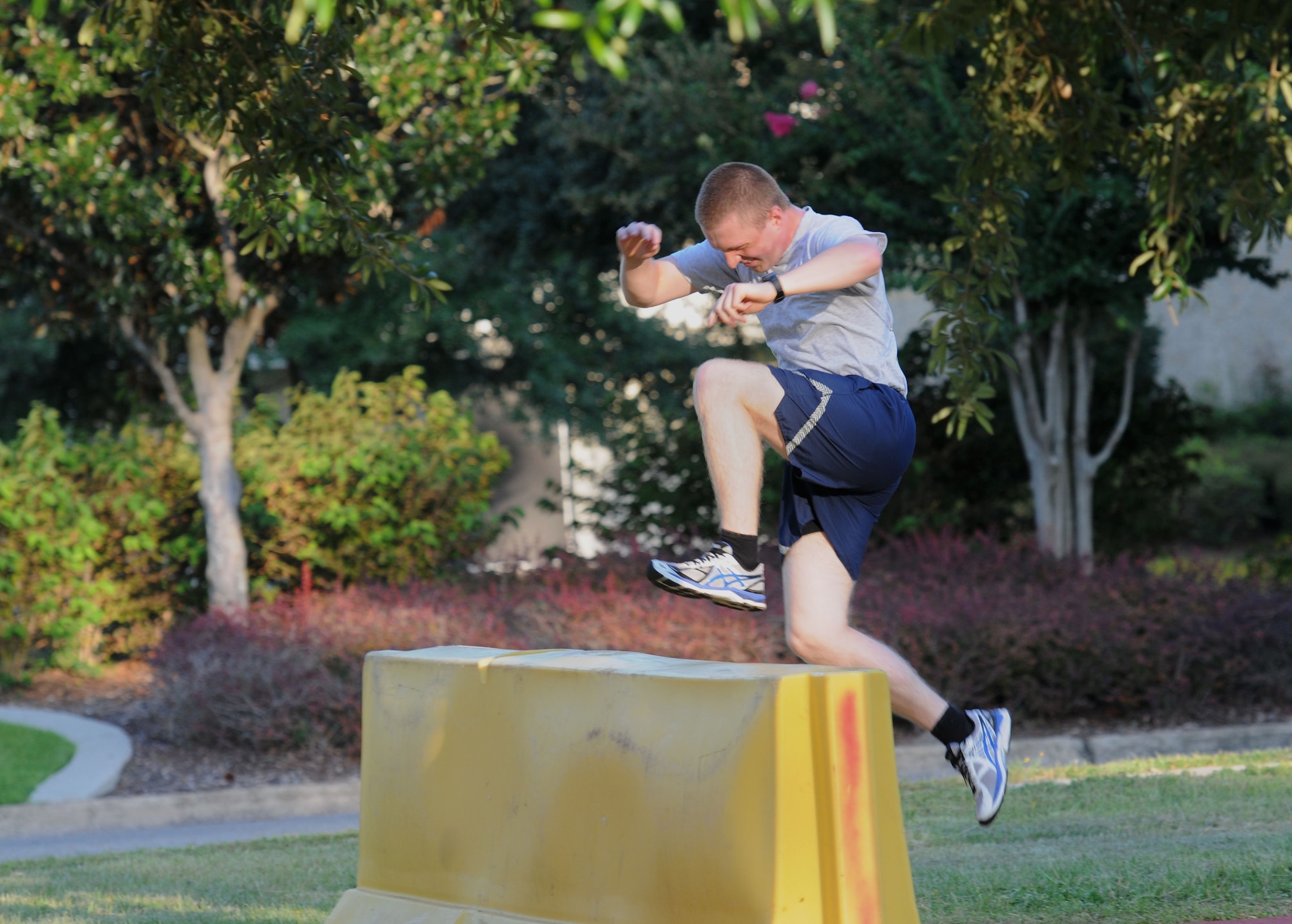 Airman Basic Brandon Samoluk, 334th Training Squadron student, hurdles over a barrier during the Gauntlet 5K & Obstacle Course event Aug. 28, 2015, at the Crotwell Track, Keesler Air Force Base, Miss. The 81st Force Support Squadron-sponsored event involved participants completing a 5K run then making their way through nine different obstacles. (U.S. Air Force photo by Kemberly Groue)