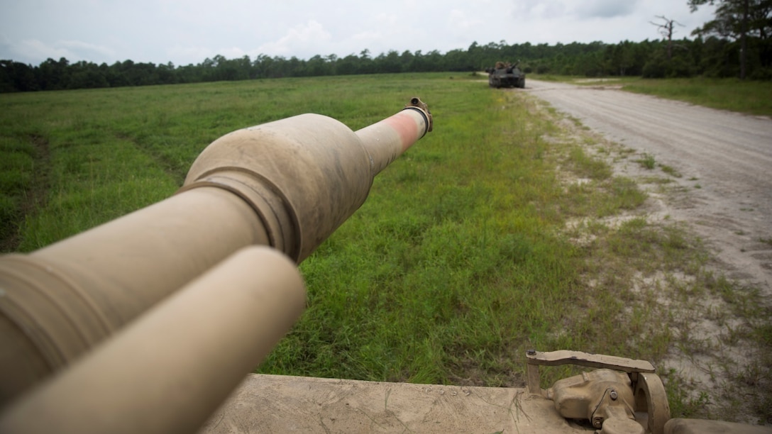 The barrel of an M1A1 Abrams main battle tank from Bravo Company, 2nd Tank Battalion, aims down toward its target during an offensive and defensive maneuver exercise at Marine Corps Base Camp Lejeune, N.C., Aug. 26, 2015. Platoons from the company practiced searching and clearing operational areas to reinforce their basic skills. The tank has a 120mm M256 smoothbore gun on the front capable of firing several types of explosive rounds. 