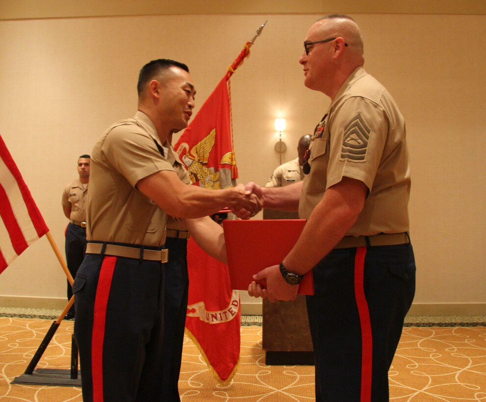 Master Sergeant John G. Barfield, operations chief for Recruiting Station Orlando, receives the Meritorious Service Medal from Maj. Richard H. Lee, commanding officer of RS Orlando, Aug., 28 2015, for his 21 years of loyal service as a Marine. Barfield plans to use the skills he developed as a Marine to achieve more great things in the civilian sector. 