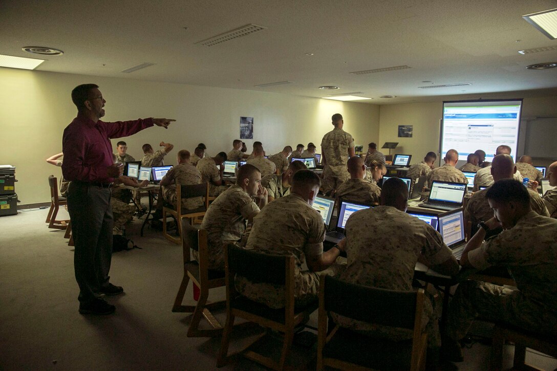 John Heidenescher, a technology trainer and curriculum developer from Jacksonville, North Carolina, teaches Marines how to use the new Mobile Field System on Camp Kinser, Aug. 4, 2015. The system, which is intended for use by small units and detachments, helps mechanics and technicians when they are not in a satellite location. It tracks all logistics, including the amount of time it takes to perform its functions and which functions are utilized while the system is disconnected. The Marines are with 3rd Maintenance Battalion, Combat Logistics Regiment 35, 3rd Marine Logistics Group, III Marine Expeditionary Force.
