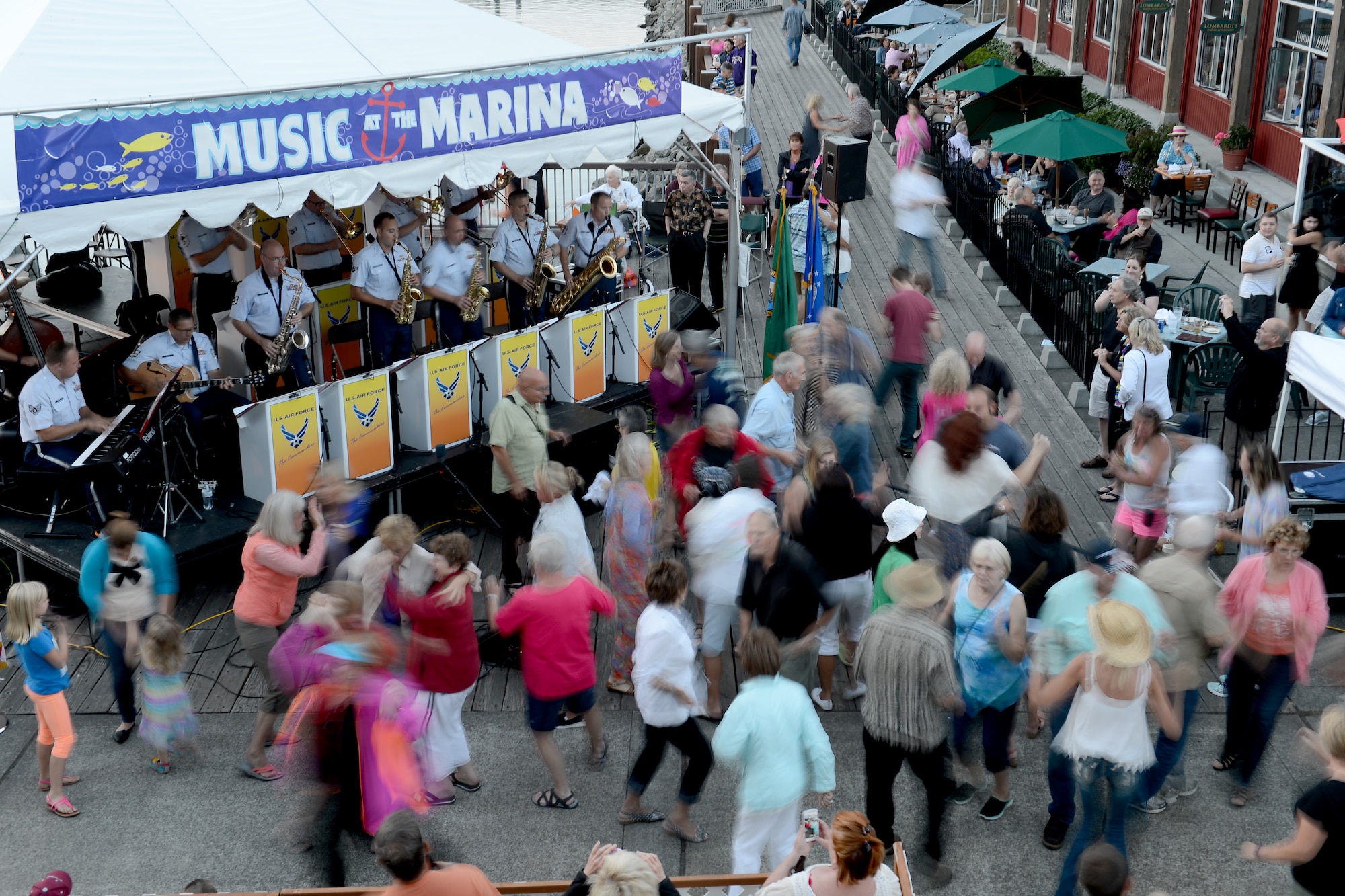 Audience members to the Air Force Band of the Golden West’s jazz ensemble, The Commanders, dance Aug. 27, 2015, at the Everett Marina, Wash. In addition to performing for civilian communities throughout the states of Western United States, the band supports 13 Air Force Bases, eight Air Force Reserve Wings, and six recruiting squadrons in over 250 annual performances for 1.5 million listeners. (U.S. Air Force photo/Airman 1st Class Keoni Chavarria)