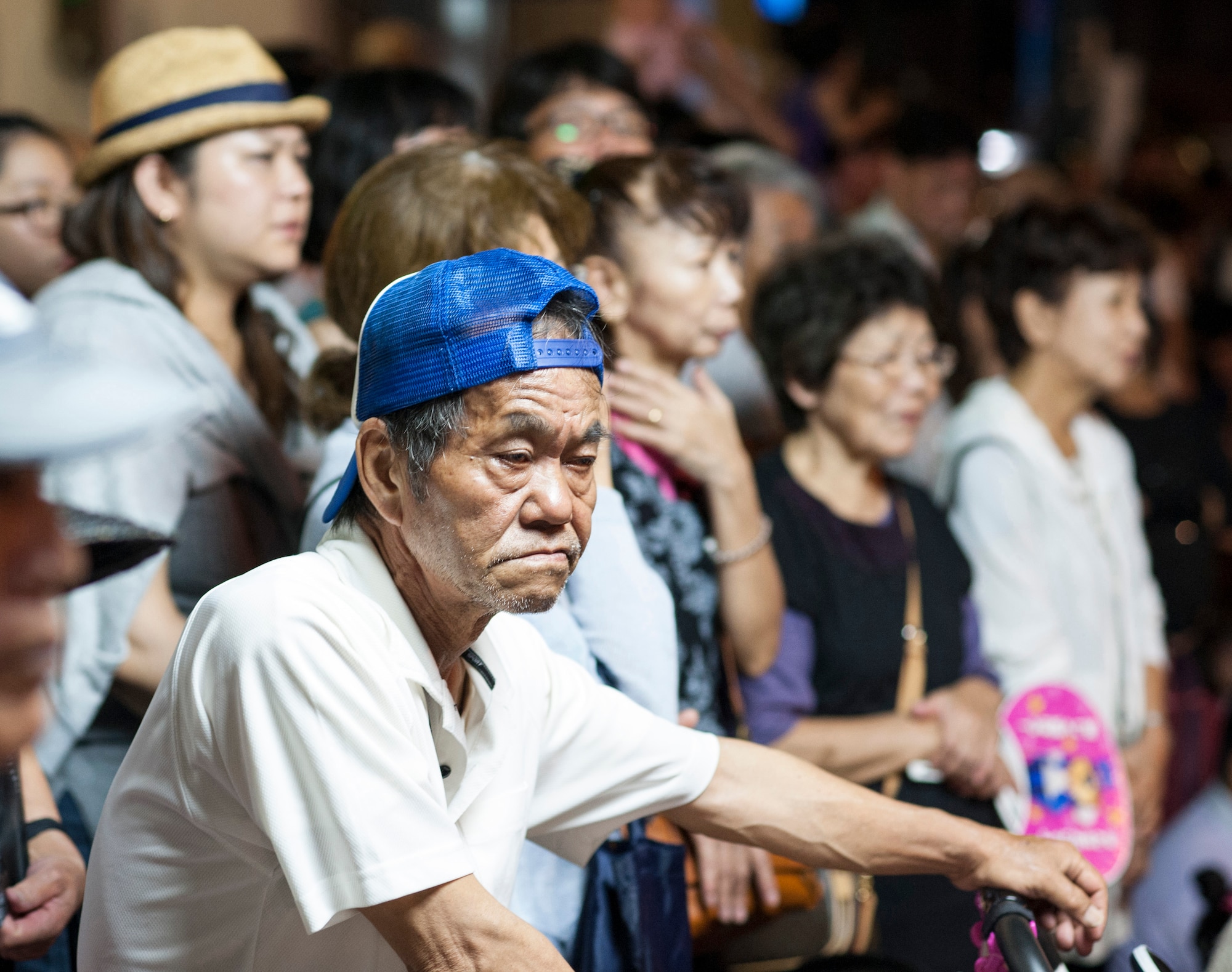 Local community members line the street to watch the performers at a Kadena Town Eisa Festival in Kadena Cho, Japan, Aug. 29, 2015. Eisa festivals are held after Obon, a three-day Okinawan holiday which celebrates life and welcomes the spirits of ancestors home for a family reunion. (U.S. Air Force photo by Master Sgt. Jason W. Edwards)
