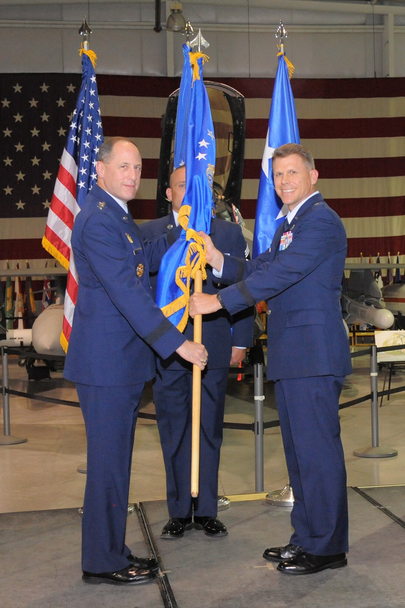 Lt. Gen. Lee K. Levy II, Air Force Sustainment Center commander, passes the guidon to Brig. Gen. Steven J. Bleymaier during the Ogden Air Logistics Complex change of command ceremony Monday, Aug. 31, at Hill Air Force Base, Utah. Bleymaier has a diversified background in fighter and heavy aircraft and munitions maintenance, acquisitions logistics, legislative liaison and politico-military plans. At Hill, he will lead a team responsible for cost, schedule and quality of depot repair, overhaul and modification of the A-10, C-130, F-16, F-22, F-35 and T-38 aircraft, the Minuteman intercontinental ballistic missile system, and numerous commodities.