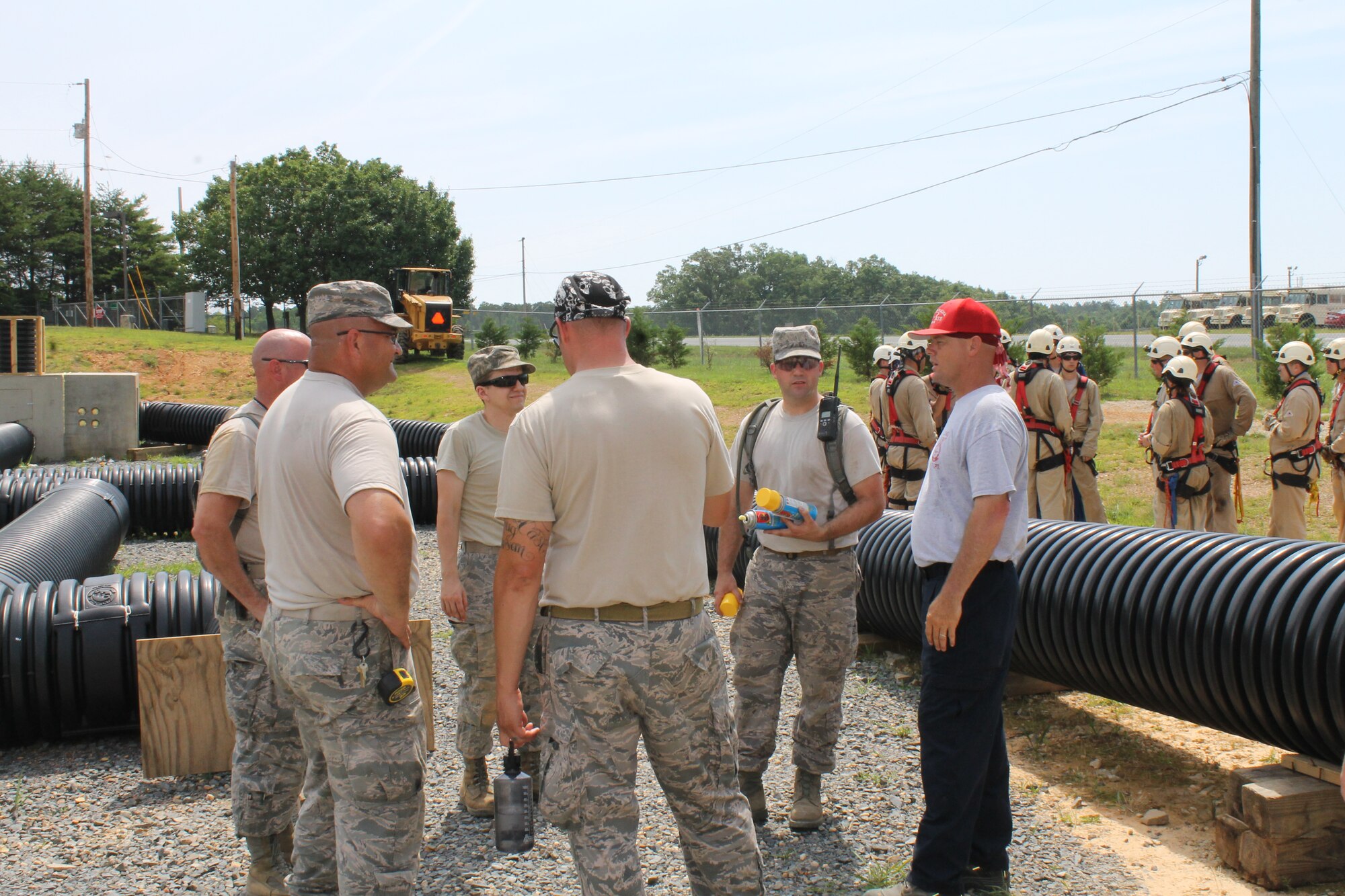 U.S. Air Force Staff Sgt. Jeret Kinnaird, firefighter for the North Carolina Air National Guard, 145th Civil Engineer Squadron, explains to visiting airmen from the Oklahoma Air National Guard, the importance of the Confined Space Trainer, as students prepare to repel during a Rescue Technician I class held at the 145th Regional Training Site, New London, N.C., June 23, 2015. Kinnaird, an instructor for ANG Rescue Technician Course, received the “Chief Albert Fitzpatrick Award” for Firefighter of the Year, July 22, 2015. (U.S. Air National Guard photo by Master Sgt. Patricia F. Moran, 145th Public Affairs/Released)