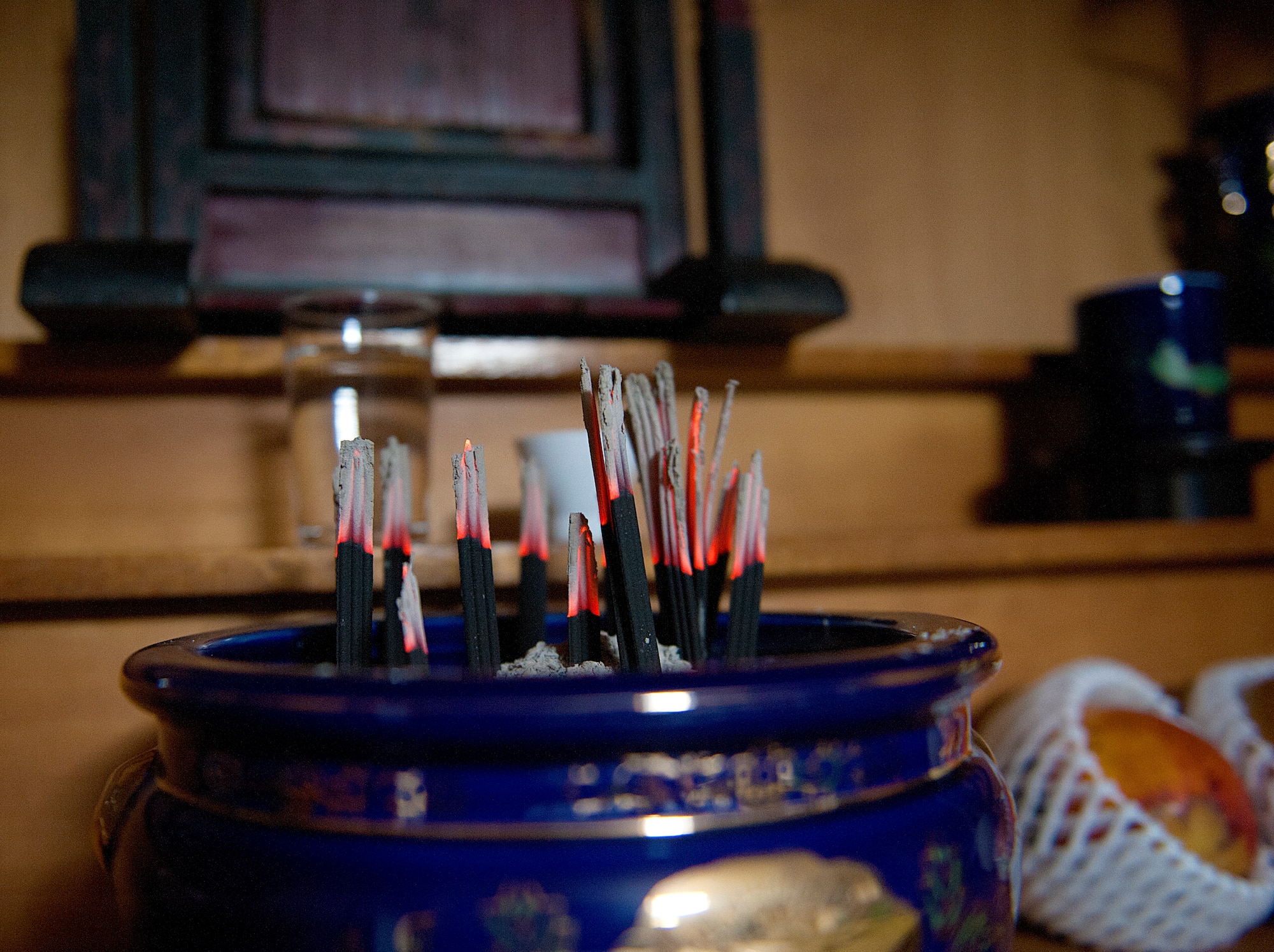 Incenses are erected in a censer in front of a butsudan as part of the Obon holiday at Yomitan village, Okinawa, Japan, Aug. 28, 2015. Ever since Obon was first celebrated approximately 500 years ago, Okinawans have followed tradition and prayed, dined, sang and danced with the spirits of their ancestors during this annual event. (U.S. Air Force photo by Naoto Anazawa)