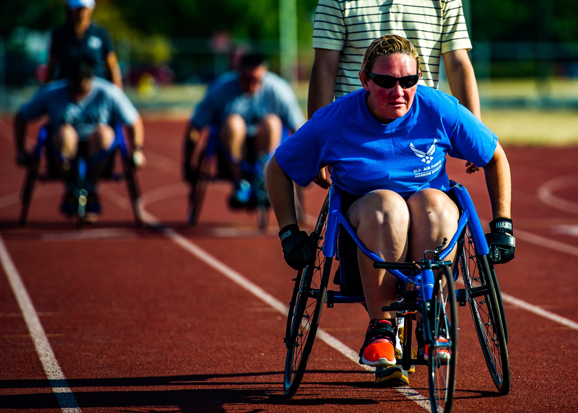 A Wounded Warrior races in a wheel chair while participating in track and field training during the Air Force Wounded Warrior Program Warrior Care event, Aug. 26, 2015 at Joint Base Lewis-McChord, Wash. The Warrior Care event featured adaptive and rehabilitative sports, activities, career readiness, recovering Airman mentorship and caregiver training. It was an opportunity for all wounded, ill and injured service members to engage in friendly competition. Wounded Warriors from JBLM and veterans from the northwest region were all invited to participate in the camp. (U.S. Air Force Reserve photo by Senior Airman Daniel Liddicoet/Released)