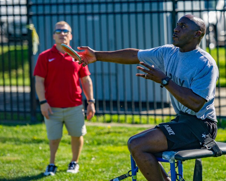 A Wounded Warrior tosses discus while participating in track and field training during the Air Force Wounded Warrior Program Warrior Care event, Aug. 26, 2015 at Joint Base Lewis-McChord, Wash. The Warrior Care event featured adaptive and rehabilitative sports, activities, career readiness, recovering Airman mentorship and caregiver training. It was an opportunity for all wounded, ill and injured service members to engage in friendly competition. Wounded Warriors from JBLM and veterans from the northwest region were all invited to participate in the camp. (U.S. Air Force Reserve photo by Senior Airman Daniel Liddicoet/Released)