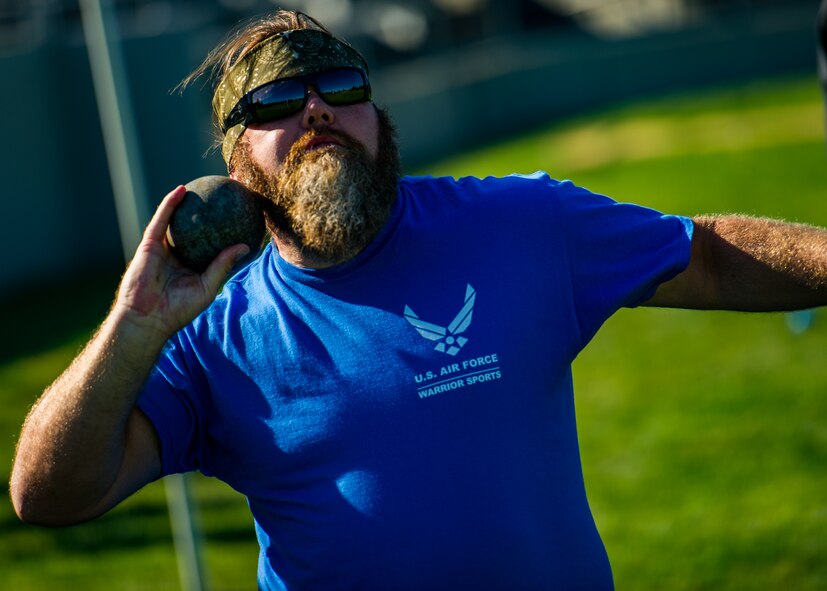 A Wounded Warrior launches a shot while participating in track and field training during the Air Force Wounded Warrior Program Warrior Care event, Aug. 26, 2015 at Joint Base Lewis-McChord, Wash. The Warrior Care event featured adaptive and rehabilitative sports, activities, career readiness, recovering Airman mentorship and caregiver training. It was an opportunity for all wounded, ill and injured service members to engage in friendly competition. Wounded Warriors from JBLM and veterans from the northwest region were all invited to participate in the camp. (U.S. Air Force Reserve photo by Senior Airman Daniel Liddicoet/Released)
