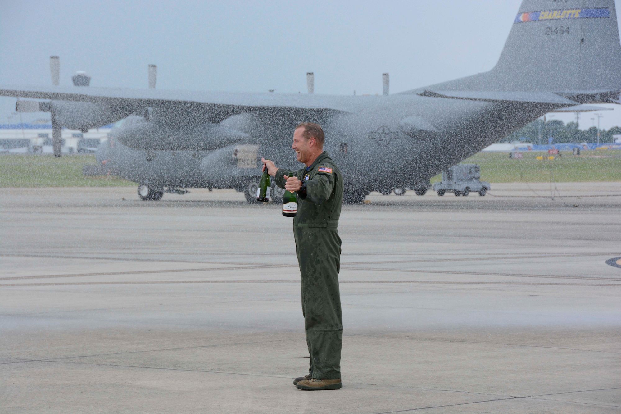 U.S. Air Force Col. Charles D. Davis III, takes on a blast of water from a fire truck after being doused with champagne following his “fini” flight at the North Carolina Air National Guard Base, Charlotte Douglas International Airport, July 28, 2015, symbolizing the end of 38 years of honorable military service. It is a tradition to spray both the aircraft and the aircrew member upon their final flight. (U.S. Air National Guard photo by Master Sgt. Patricia F. Moran, 145th Public Affairs/Released)
