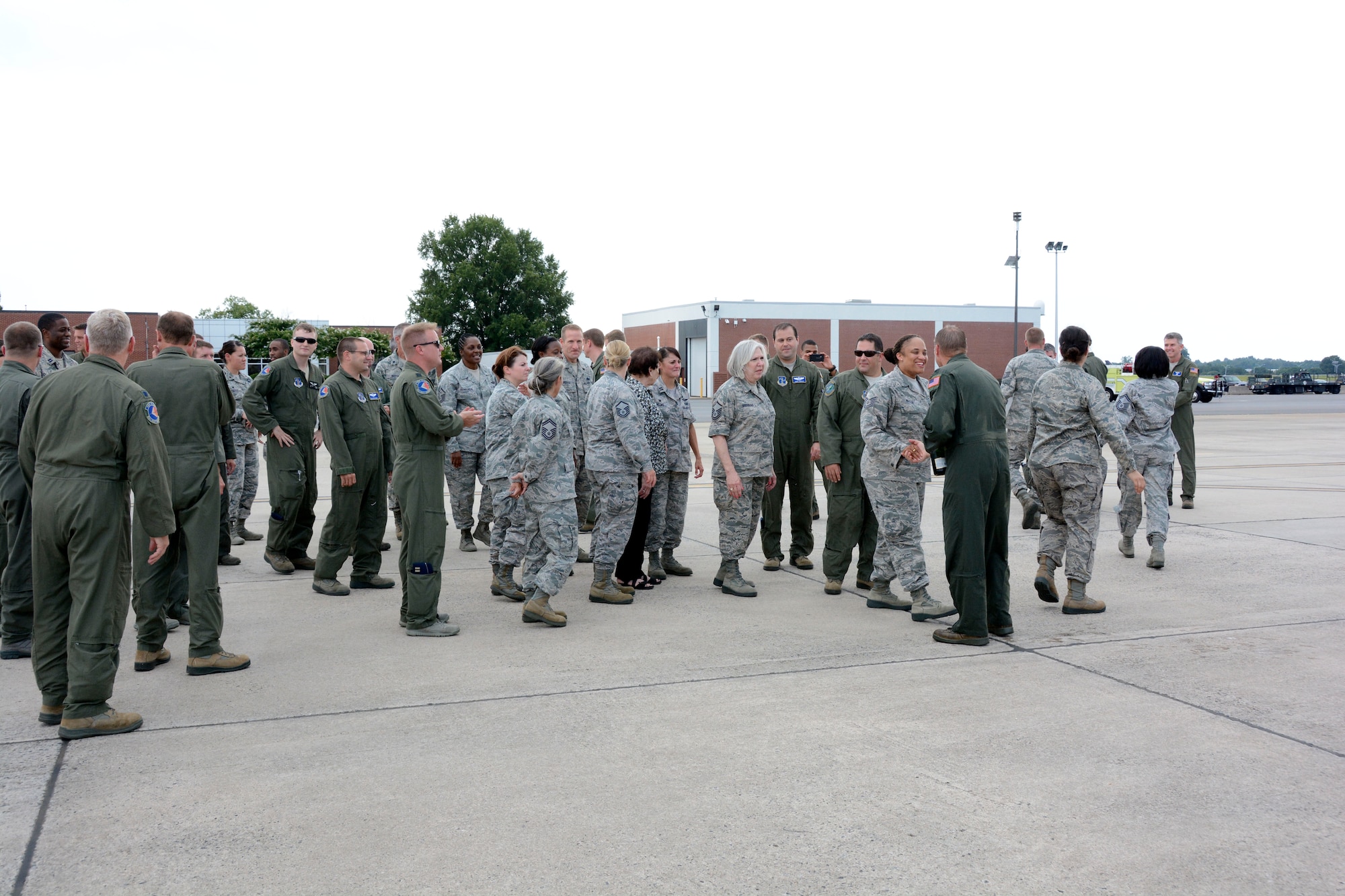 U.S. Air Force Col. Charles D. Davis III, is greeted and congratulated by members of the 145th Airlift Wing following his final flight onboard a 145th Airlift Wing, C-130 Hercules aircraft at the North Carolina Air National Guard Base, Charlotte Douglas International Airport, July 28, 2015. In a tradition nearly as old as military aviation itself, the “fini” flight symbolizes the end of Davis’ 38 years of honorable military service. (U.S. Air National Guard photo by Master Sgt. Patricia F. Moran, 145th Public Affairs/Released)