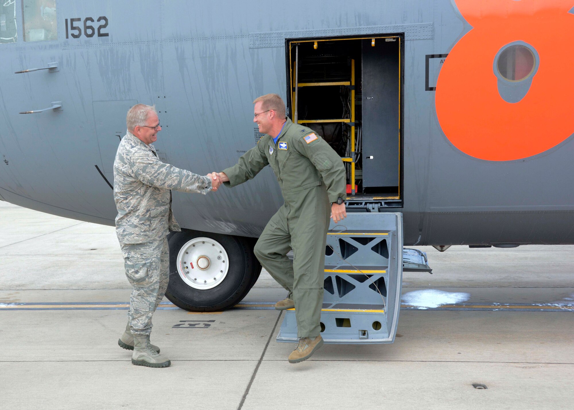 U.S. Air Force Col. Marshall C. Collins, Commander, North Carolina Air National Guard, congratulates Col. Charles D. Davis III, following his final flight onboard a 145th Airlift Wing C-130 Hercules aircraft, at the North Carolina Air National Guard Base, Charlotte Douglas International Airport, July 28, 2015. Davis completed his “fini” flight, symbolizing the end of 38 years of honorable military service. (U.S. Air National Guard photo by Master Sgt. Patricia F. Moran, 145th Public Affairs/Released)