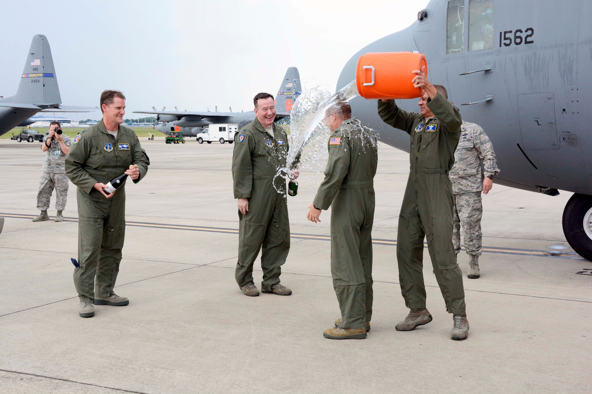 In a tradition nearly as old as military aviation itself, U.S. Air Force Col. Charles D. Davis III, gets doused with a bucket of ice water by Lt. Col. James Pearson, Chief of Current Operations, 145th Operations Support Squadron, following his “fini” flight, at the North Carolina Air National Guard Base, Charlotte Douglas International Airport, July 28, 2015, symbolizing the end of 38 years of honorable military service. (U.S. Air National Guard photo by Master Sgt. Patricia F. Moran, 145th Public Affairs/Released)