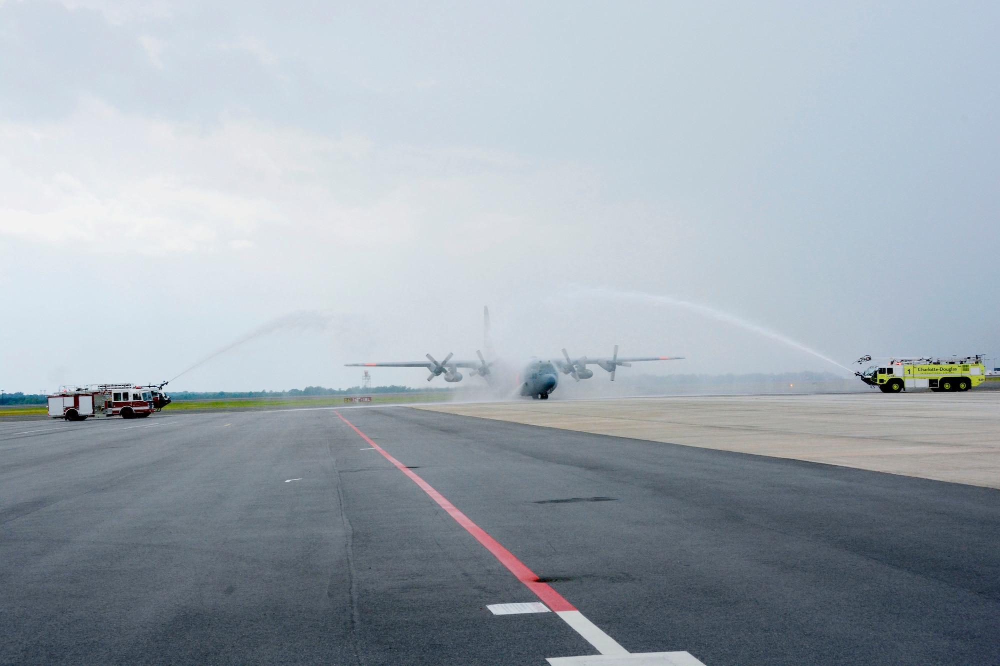 A 145th Airlift Wing C-130 Hercules aircraft made its way beneath an arc of water spraying from two fire trucks as it taxied to its parking spot. In a tradition nearly as old as military aviation itself, Col. Charles D. Davis III, completed his final “fini” flight at the North Carolina Air National Guard base, Charlotte Douglas International Airport, July 28, 2105, symbolizing the end of 38 years of honorable military service. (U.S. Air National Guard photo by Master Sgt. Patricia F. Moran, 145th Public Affairs/Released)