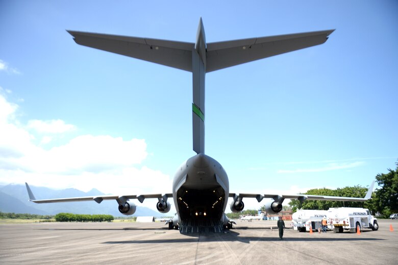 A C-17 Globemaster III from the 62nd Airlift Wing out of Joint Base Lewis-McChord, Wash., sits on the tarmac at Base Aerea Coronel Hector Caraccioli Moncada in La Ceiba, Honduras, Aug. 28, 2015, while it is loaded with New Horizons Honduras 2015 training exercise gear and personnel. The C-17 transported New Horizons vehicles, equipment and personnel to Hurlburt Field, Fla., while all remaining equipment will be transported via sealift. New Horizons was launched in the 1980s and is an annual joint humanitarian assistance exercise that U.S. Southern Command conducts with a partner nation in Central America, South America or the Caribbean. The exercise improves joint training readiness of U.S. and partner nation civil engineers, medical professionals and support personnel through humanitarian assistance activities. (U.S. Air Force photo by Capt. David J. Murphy/Released)