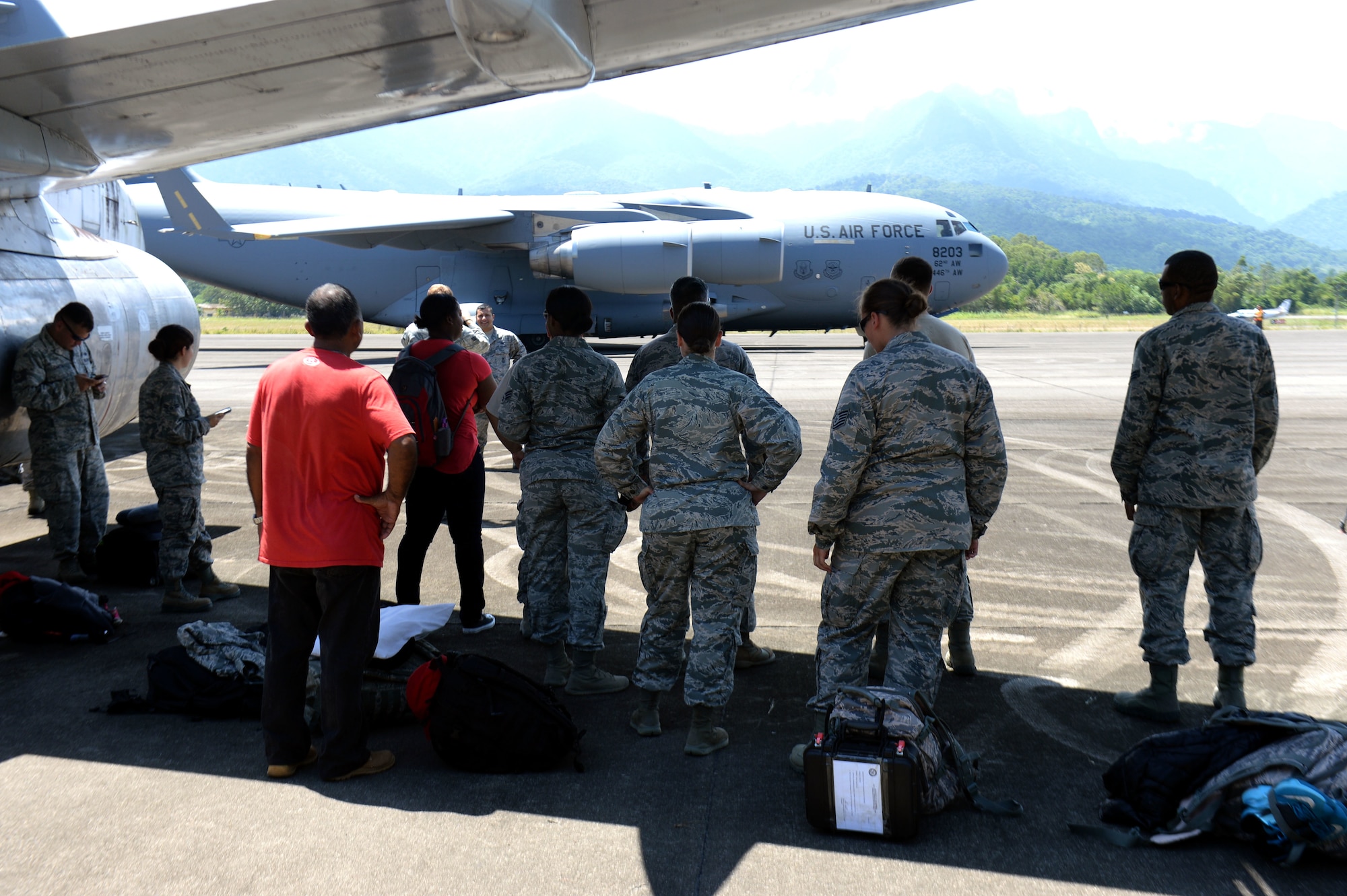 New Horizons Honduras 2015 training exercise personnel wait to board a C-17 Globemaster III from the 62nd Airlift Wing out of Joint Base Lewis-McChord, Wash., as it arrives at Base Aerea Coronel Hector Caraccioli Moncada in La Ceiba, Honduras, Aug. 28, 2015. The C-17 transported New Horizons vehicles, equipment and personnel to Hurlburt Field, Fla., while all remaining equipment will be transported via sealift. New Horizons was launched in the 1980s and is an annual joint humanitarian assistance exercise that U.S. Southern Command conducts with a partner nation in Central America, South America or the Caribbean. The exercise improves joint training readiness of U.S. and partner nation civil engineers, medical professionals and support personnel through humanitarian assistance activities. (U.S. Air Force photo by Capt. David J. Murphy/Released)