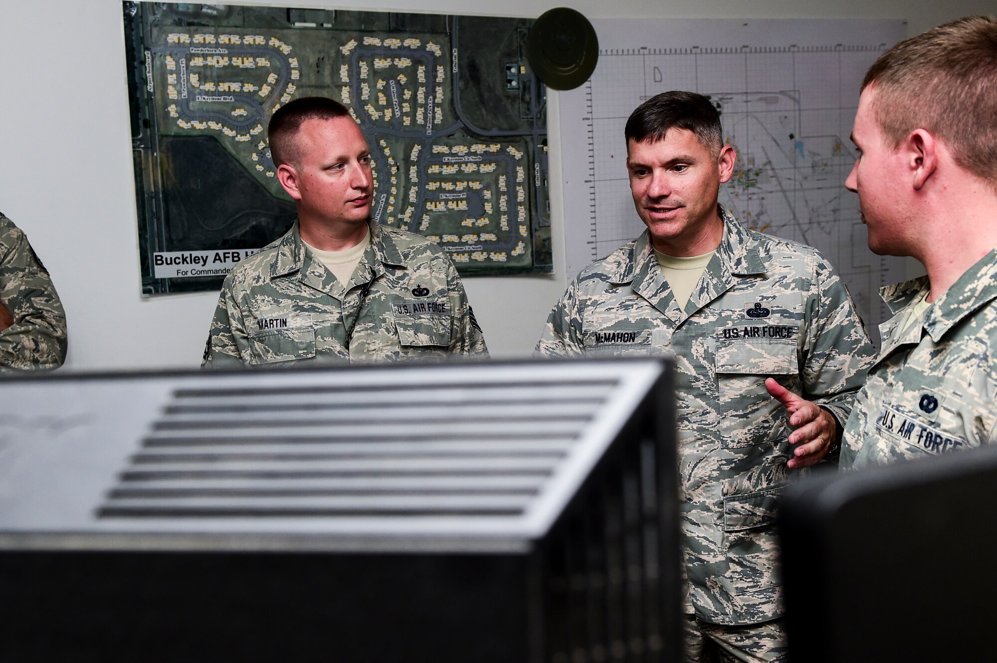 Chief Master Sgt. Patrick McMahon, Air Force Space Command command chief, middle, is briefed by members of the Base Defense Operations Center Aug. 28, 2015 at the security forces building on Buckley Air Force Base, Colo. McMahon visited Buckley AFB for the first time after becoming the senior enlisted leader of Air Force Space Command, communicating his goals, answering Airman’s questions and recognizing outstanding performers. (U.S. Air Force photo by Senior Airman Phillip Houk/Released)