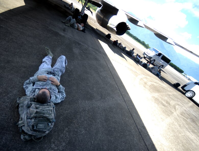 New Horizons Honduras 2015 training exercise personnel wait in the shade of an aircraft for their flight back to the United States from Base Aerea Coronel Hector Caraccioli Moncada in La Ceiba, Honduras, Aug. 28, 2015. Vehicles, equipment and personnel that were part of the New Horizons exercise redeployed to Hurlburt Field, Fla., while all remaining equipment will return via sealift. New Horizons was launched in the 1980s and is an annual joint humanitarian assistance exercise that U.S. Southern Command conducts with a partner nation in Central America, South America or the Caribbean. The exercise improves joint training readiness of U.S. and partner nation civil engineers, medical professionals and support personnel through humanitarian assistance activities. (U.S. Air Force photo by Capt. David J. Murphy/Released)