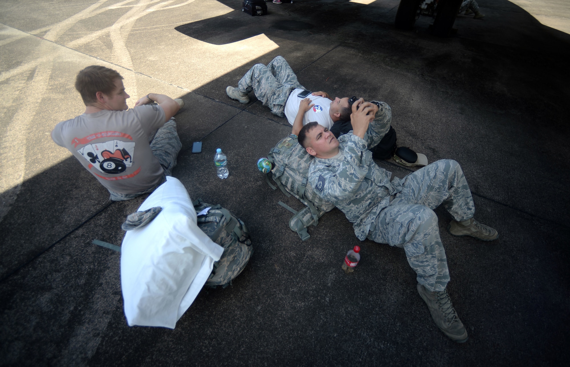 New Horizons Honduras 2015 training exercise personnel wait in the shade of an aircraft for their flight back to the United States from Base Aerea Coronel Hector Caraccioli Moncada in La Ceiba, Honduras, Aug. 28, 2015. Vehicles, equipment and personnel that were part of the New Horizons exercise redeployed to Hurlburt Field, Fla., while all remaining equipment will return via sealift. New Horizons was launched in the 1980s and is an annual joint humanitarian assistance exercise that U.S. Southern Command conducts with a partner nation in Central America, South America or the Caribbean. The exercise improves joint training readiness of U.S. and partner nation civil engineers, medical professionals and support personnel through humanitarian assistance activities. (U.S. Air Force photo by Capt. David J. Murphy/Released)