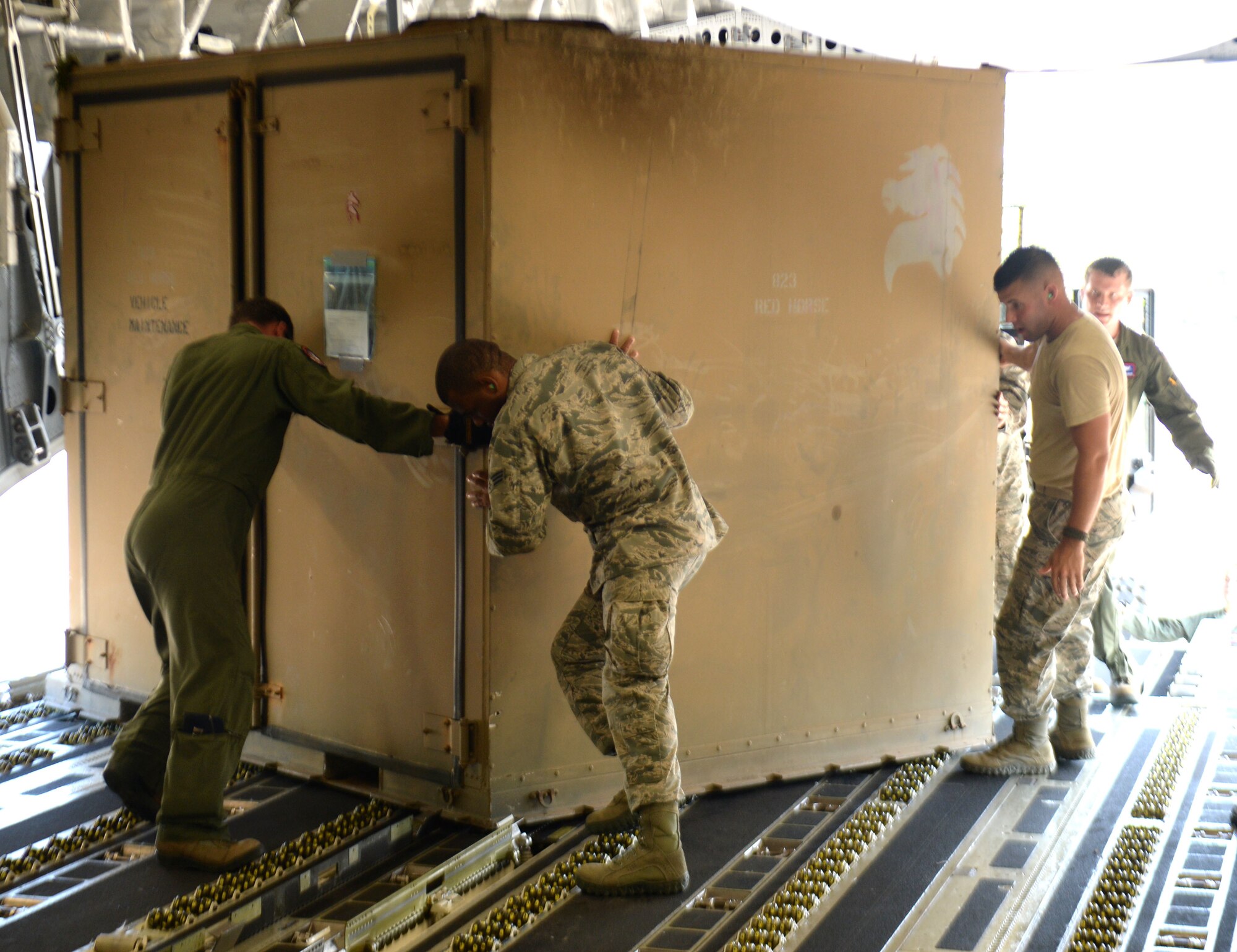 New Horizons Honduras 2015 training exercise personnel assist with the loading of equipment onto the C-17 Globemaster III from the 62nd Airlift Wing out of Joint Base Lewis-McChord, Wash., prior to departure from Base Aerea Coronel Hector Caraccioli Moncada in La Ceiba, Honduras, Aug. 28, 2015. The New Horizons members were redeploying to Hurlburt Field, Fla. New Horizons was launched in the 1980s and is an annual joint humanitarian assistance exercise that U.S. Southern Command conducts with a partner nation in Central America, South America or the Caribbean. The exercise improves joint training readiness of U.S. and partner nation civil engineers, medical professionals and support personnel through humanitarian assistance activities. (U.S. Air Force photo by Capt. David J. Murphy/Released)