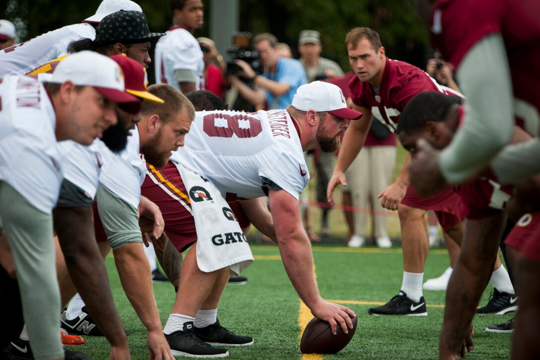 Washington Redskins players line up to run a play during a walkthrough practice at the West Fitness Center’s field, Joint Base Andrews, Md., Aug. 28, 2015. The Redskins practice was followed by an autograph session with fans as part of their Redskins Salute effort. (U.S. Air Force photo by Airman 1st Class Philip Bryant/Released)