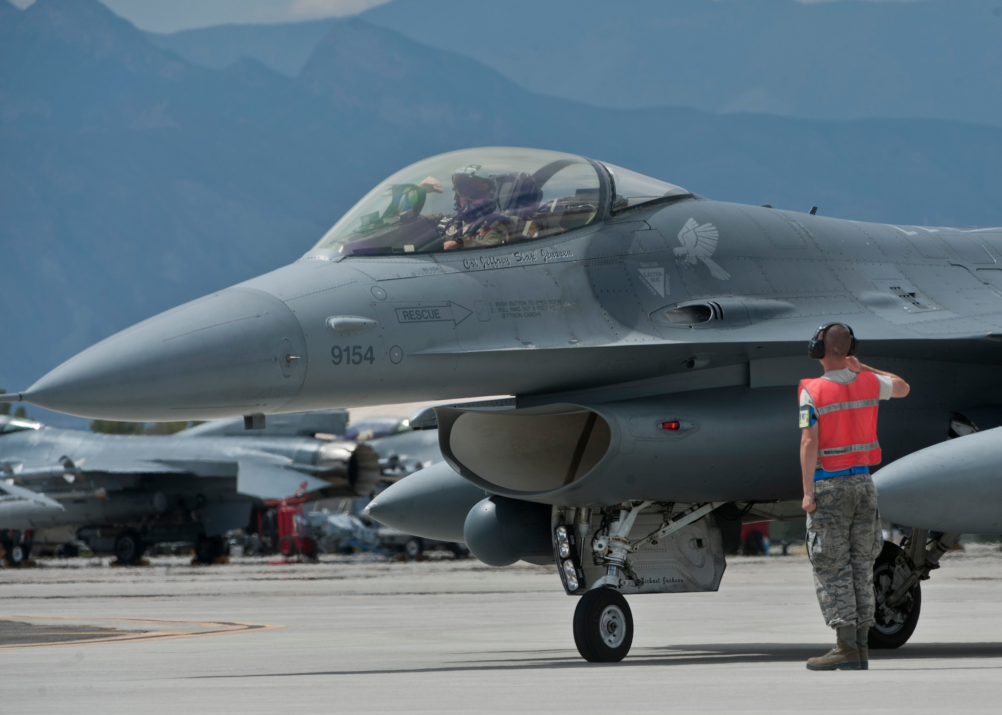 An F-16 Fighting Falcon pilot assigned to the 311th Fighter Squadron, Holloman Air Force Base N.M., salutes a crew chief before taking off as part on an exercise during Red Flag 15-4 at Nellis Air Force Base, Nev., Aug. 27, 2015. Red Flag involves a series of intense air-to-air combat exercises designed to prepare U.S. and allied forces for future real world conflicts. (U.S. Air Force photo by Airman 1st Class Jake Carter)