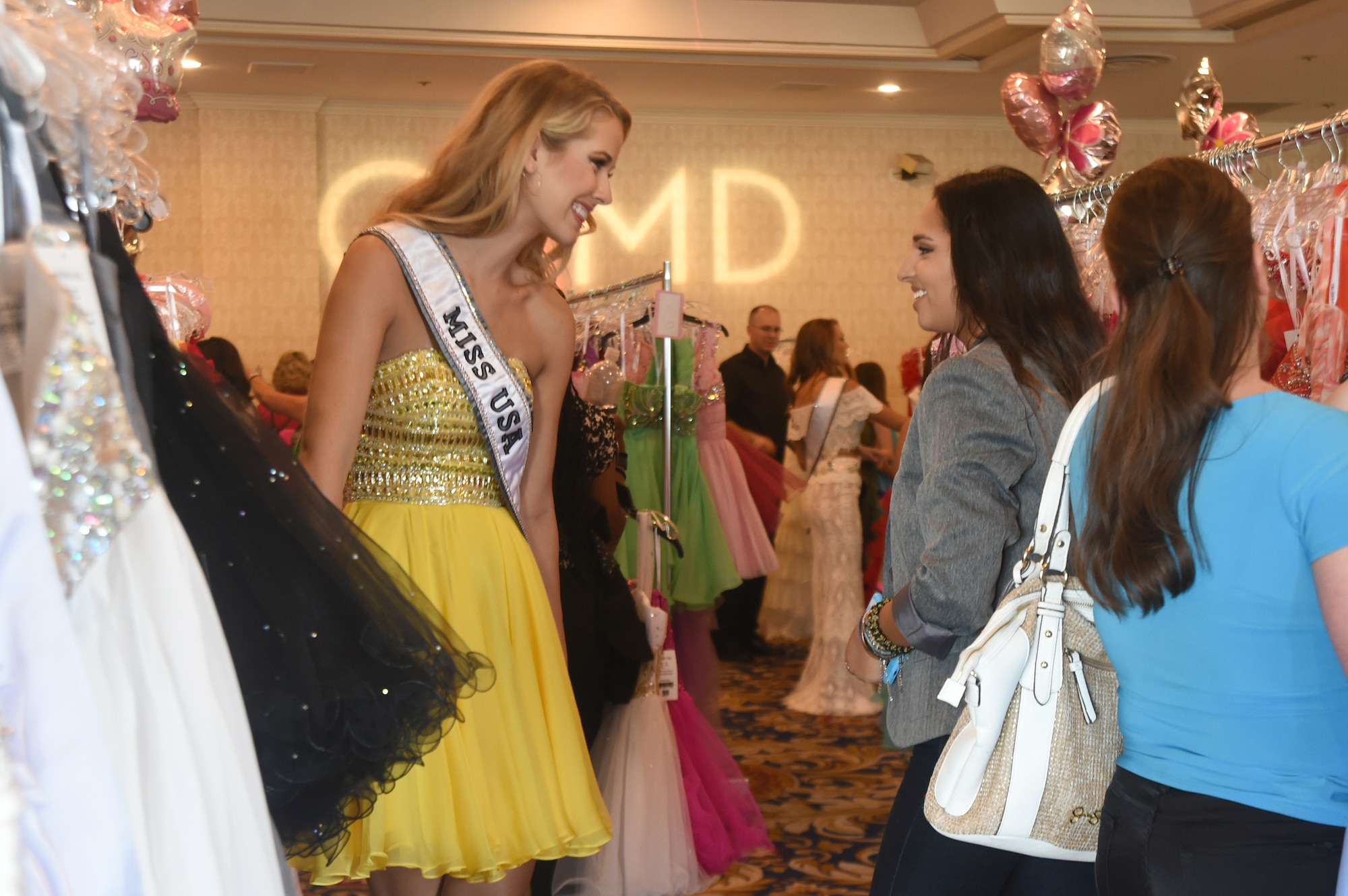 (Right) Olivia Jordan, 2015 Miss USA, helps Paulina Hernandez, 15, find dresses that fit her unique style during the USO sponsored Operation That’s My Dress event in Las Vegas, Aug. 30, 2015. Miss USA commended service members and their families for the sacrifices they make every day in the defense or our country. (U.S. Air Force photo by Tech. Sgt. Nadine Barclay)