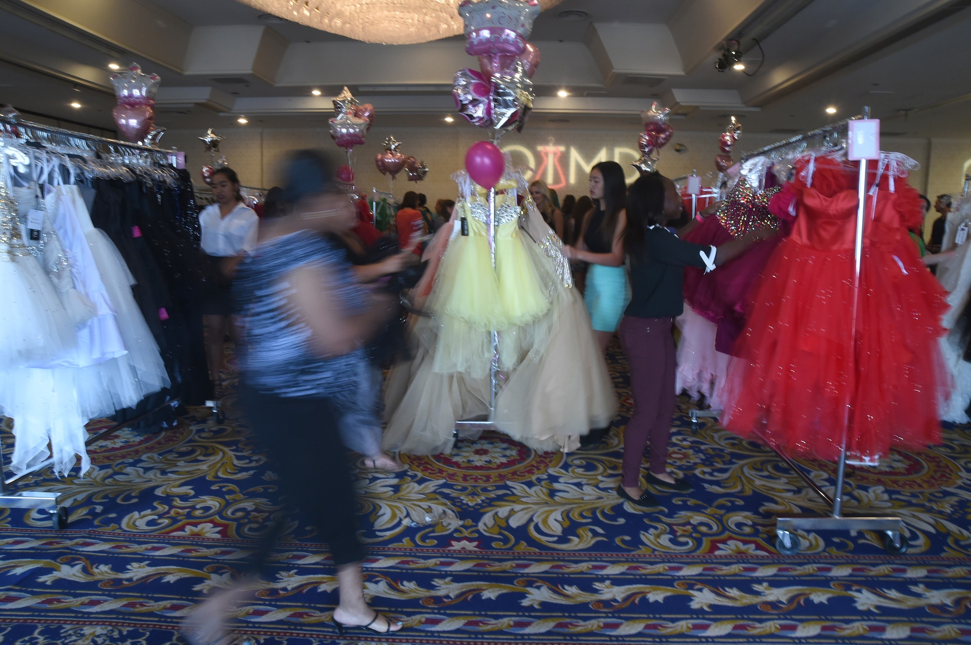 Women scramble to find dresses to try on during the USO sponsored Operation That’s My Dress event in Las Vegas, Aug. 30, 2015. More than 1500 dresses in multiple sizes- valued between $400 and $1200- were donated to over 800 active duty females, spouses, and teenage daughters as a thank you for their service and sacrifice. (U.S. Air Force photo by Tech. Sgt. Nadine Barclay)