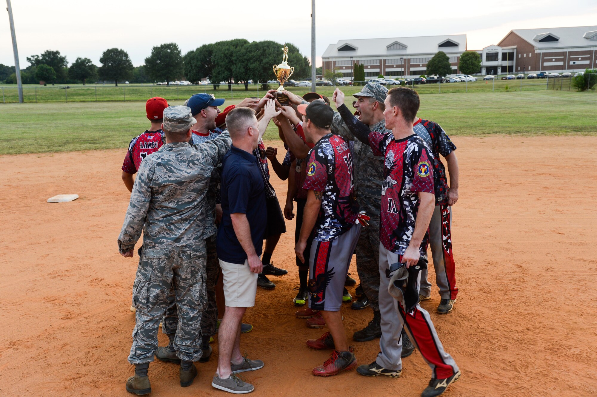 The 45th Intelligence Squadron softball team shouts their squadron chant following their victory in the 2015 Intramural Softball Championship at Langley Air Force Base, Va., Aug. 25, 2015. The 45th IS finished the regular season with a record of seven wins and three losses before defeating the 633rd Civil Engineer Squadron in the championship game. (U.S. Air Force photo by Senior Airman Kayla Newman/Released)