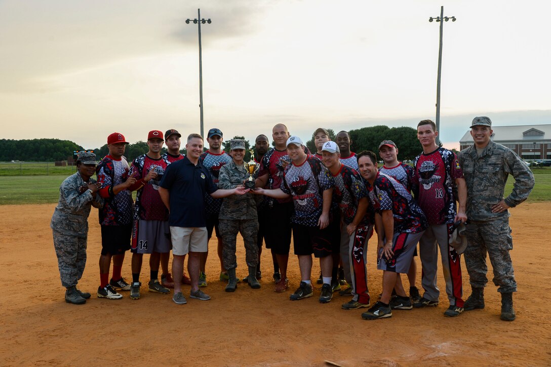 The 2015 Intramural Softball Champions, the 45th Intelligence Squadron, pose for a picture with Col. Caroline Miller, 633rd Air Base Wing commander, at Langley Air Force Base, Va., Aug. 25, 2015. The 45th IS defeated the defending softball champions, the 633rd Civil Engineer Squadron, to take home the title. (U.S. Air Force photo by Senior Airman Kayla Newman/Released)