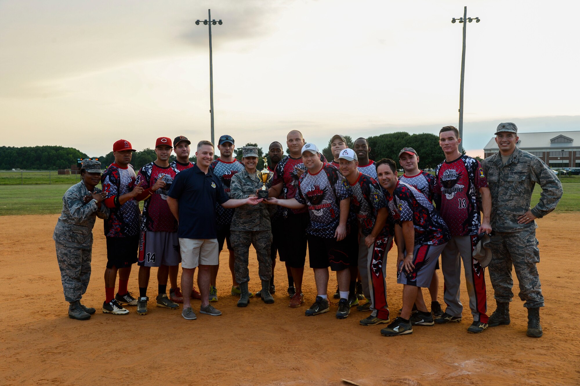 The 2015 Intramural Softball Champions, the 45th Intelligence Squadron, pose for a picture with Col. Caroline Miller, 633rd Air Base Wing commander, at Langley Air Force Base, Va., Aug. 25, 2015. The 45th IS defeated the defending softball champions, the 633rd Civil Engineer Squadron, to take home the title. (U.S. Air Force photo by Senior Airman Kayla Newman/Released)