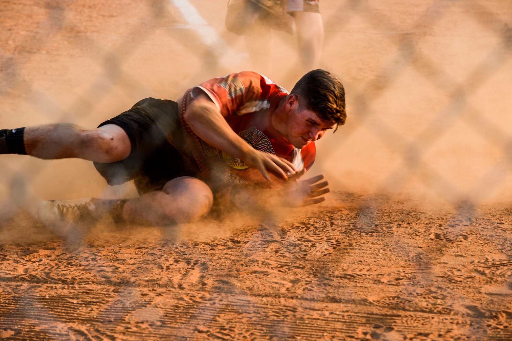 U.S. Air Force Airman 1st Class Matthew Stiltner, 633rd Civil Engineer Squadron team member, slides into home plate during the 2015 Intramural Softball Championship at Langley Air Force Base, Va., Aug. 25, 2015. Stiltner and his teammates played against the 45th Intelligence Squadron in a game hosted by the 633rd Air Base Wing commander, Col. Caroline Miller. (U.S. Air Force photo by Senior Airman Kayla Newman/Released)