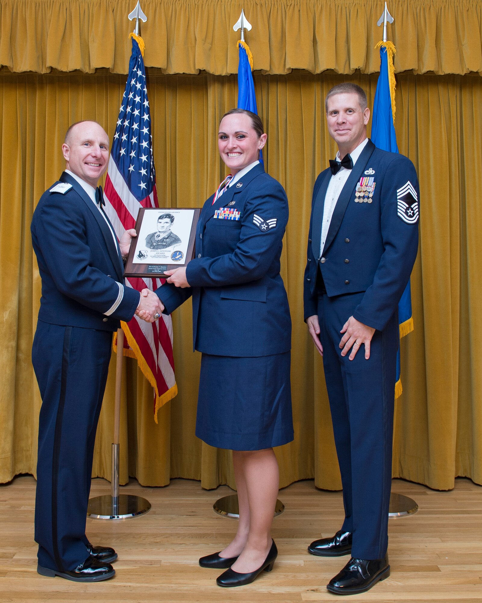 Senior Airman Catherine Bensken, 73rd Aerial Port Squadron, excepts the John L. Levitow Award from Brig. Gen. Carl Schaefer, 412th Test Wing commander (left), as Chief Master Sgt. Kennon Arnold, 412th Maintenance Group, looks on. The John L. Levitow Award is the highest award for enlisted professional military education in the Air Force and is presented to the student who demonstrates the most outstanding leadership and scholastic achievement throughout Airman Leadership School, the NCO Academy and the Senior NCO Academy. (U.S. Air Force photo by Ethan Wagner)

Only one student receives this award in each class and classes can vary in size, depending on base or school. 