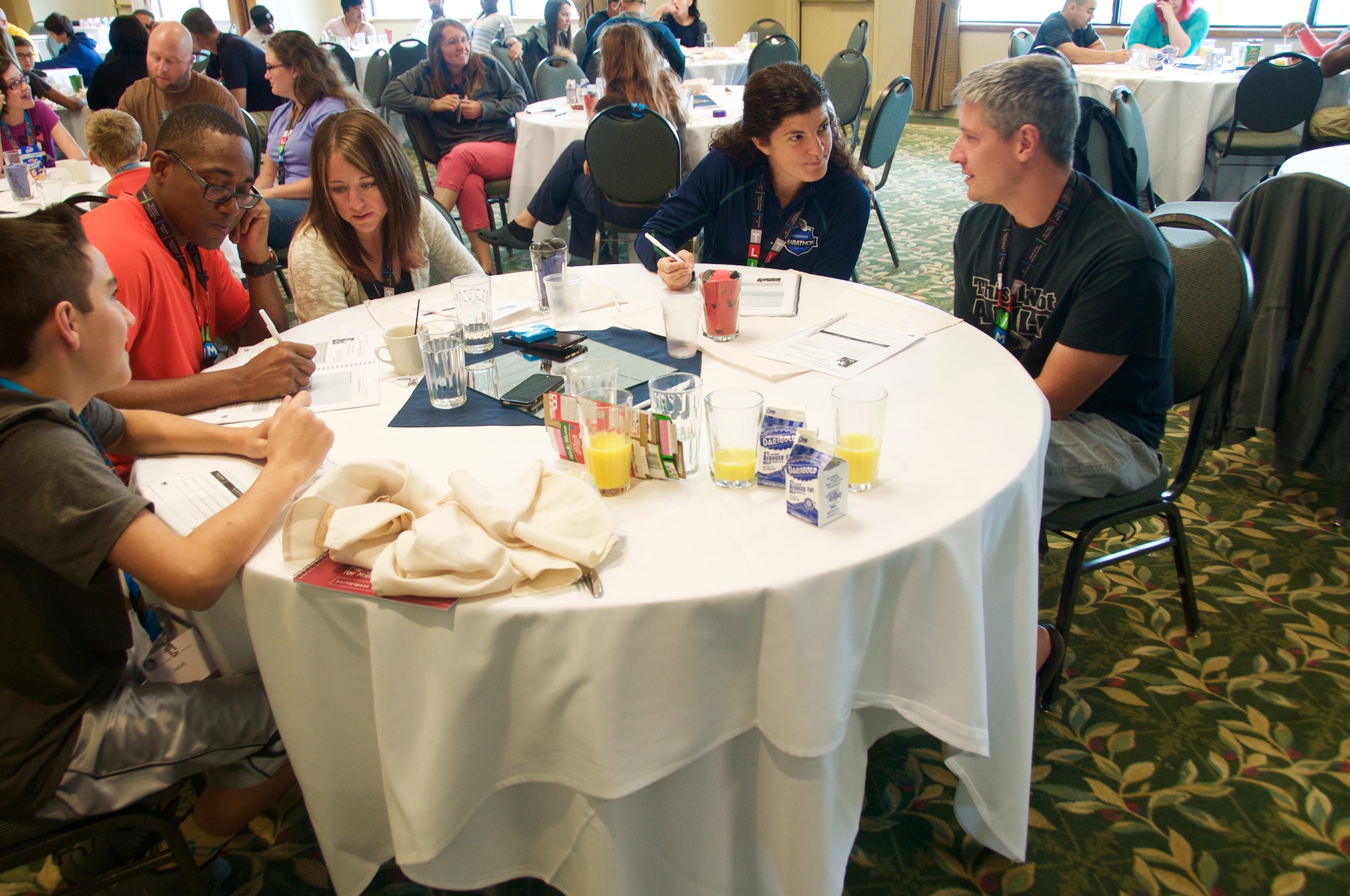 Several Team Fairchild families go through a workbook and discuss their goals during a family retreat August 29, 2015 in Post Falls, Id. The family retreat was hosted by the 92nd ARW Chapel and was free of charge for Team Fairchild families.