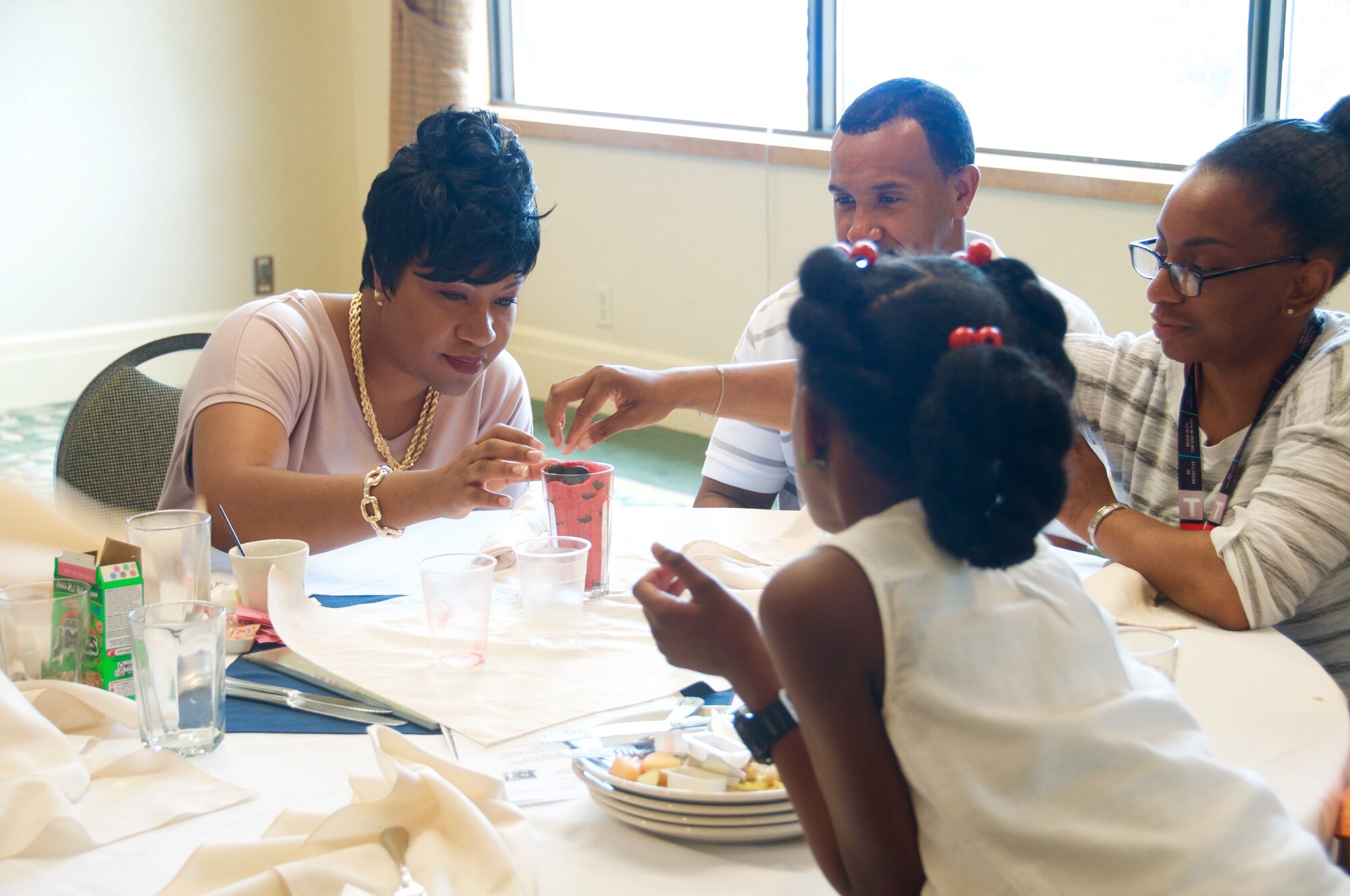 Master Sgt. Solitha Holloway, 92nd ARW Protocol superintendent, along with Tech. Sgt. Katina Fraley, 92 MDG Diagnostic Imaging noncommissioned officer in charge, and her family participate in a priority management activity during a family retreat August 29, 2015 in Post Falls, Id. The family retreat was hosted by the 92nd ARW Chapel and was free of charge for Team Fairchild families. 