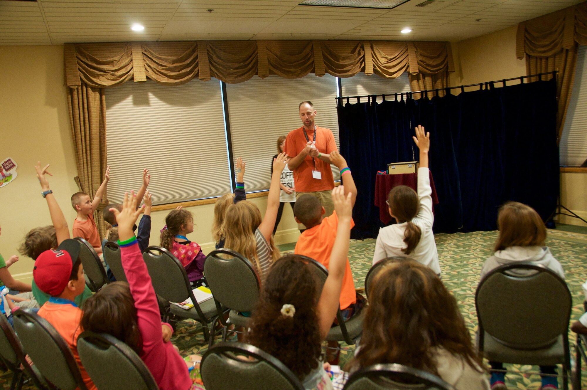 Team Fairchild youth eagerly volunteer to participate in a magic trick at the 92 ARW Chapel Family Retreat, August 29, 2015 in Post Falls, Id. Children younger than 11 attended breakout sessions where they studied “The Seven Habits of Happy Kids” by Stephen R. Covey. 