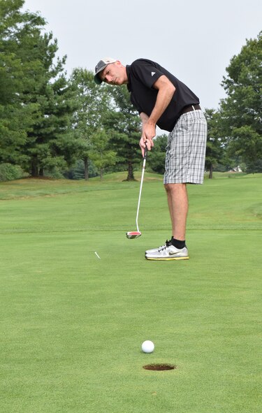 HORSHAM AIR GUARD STATION, Pa. – Never a doubt as Lt. Col. John Commins, chief of wing safety with the 111th ATKW, sinks his 18th hole putt during the Friends of the Family Readiness charity golf outing held at the Pinecrest Golf Club, Montgomeryville, Pa., Aug. 31, 2015. The best ball, scramble event brought together nearly 50 unit members and civilians for a day of fun and summertime leisure. (U.S. Air National Guard photo by Master Sgt. Christopher Botzum/Released)