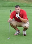 HORSHAM AIR GUARD STATION, Pa. – Tech. Sgt. Kevin Bliem, knowledge operations technician with the 111th Air Operations Group, ponders his shot line for his 9th hole putt during the Friends of the Family Readiness charity golf outing held at the Pinecrest Golf Club, Montgomeryville, Pa., Aug. 31, 2015. The best ball, scramble event brought together nearly 50 unit members and civilians for a day of fun and summertime leisure. (U.S. Air National Guard photo by Master Sgt. Christopher Botzum/Released)