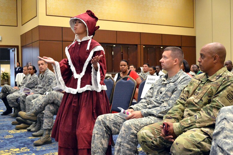 Air Force Staff Sgt. Jessica Cruz, 43rd Air Mobility Squadron, dressed as Susan B. Anthony, performs a women’s suffrage movement skit during an observance for Women’s Equality Day Aug. 26, 2015, at the Catering and Conference Center Fort Bragg, North Carolina. Women’s Equality Day is a symbol of women’s continued fight for equal rights and that the United States commends and supports them. Today, it is celebrated in honor of modern day women's rights to be seen as equals to men. (U.S. Air Force photo/Marvin Krause)