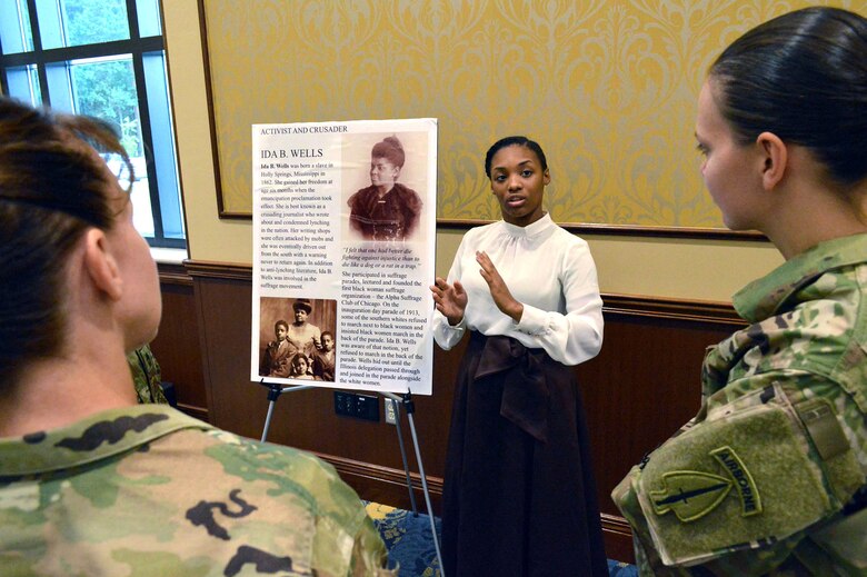 Air Force Senior Airman Quatisha Farland, 43rd Air Base Squadron, dressed as Ida E. Wells, role-plays with Women’s Equality Day observance attendees, answering questions and explaining what they accomplished for women’s equality Aug. 26, 2015, at the Catering and Conference Center Fort Bragg, North Carolina. Women’s Equality Day is a symbol of women’s continued fight for equal rights and that the United States commends and supports them. Today, it is celebrated in honor of modern day women's rights to be seen as equals to men. (U.S. Air Force photo/Marvin Krause)